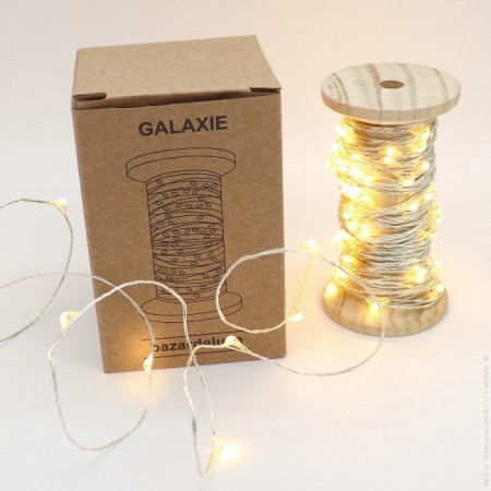 Silver galaxy led garland on vintage wooden coil