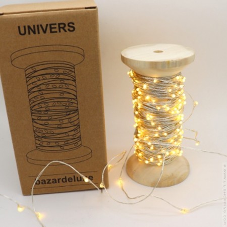 Univers led garland on vintage wooden coil
