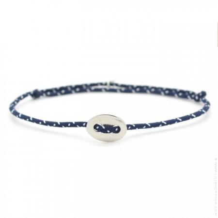 Silver button on a navy blue and white paracord bracelet