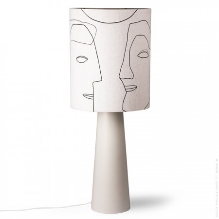 Printed faces on a cone base table lamp