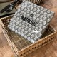 Natural and black seagrass napkin holder