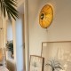 One round gold raffia wall lamp