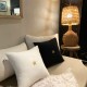 Square old white linen cushion with a gold star