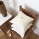 Square old white linen cushion with a gold star