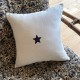 Square old white linen cushion with a black star