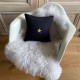 Square black linen cushion with a gold star