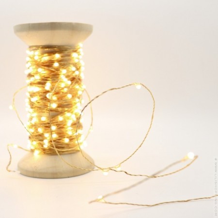 Gold Univers led garland on vintage wooden coil